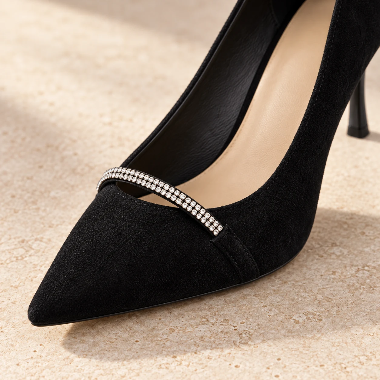 Rear close-up of the black suede heel counter and 70 mm flared stiletto heel