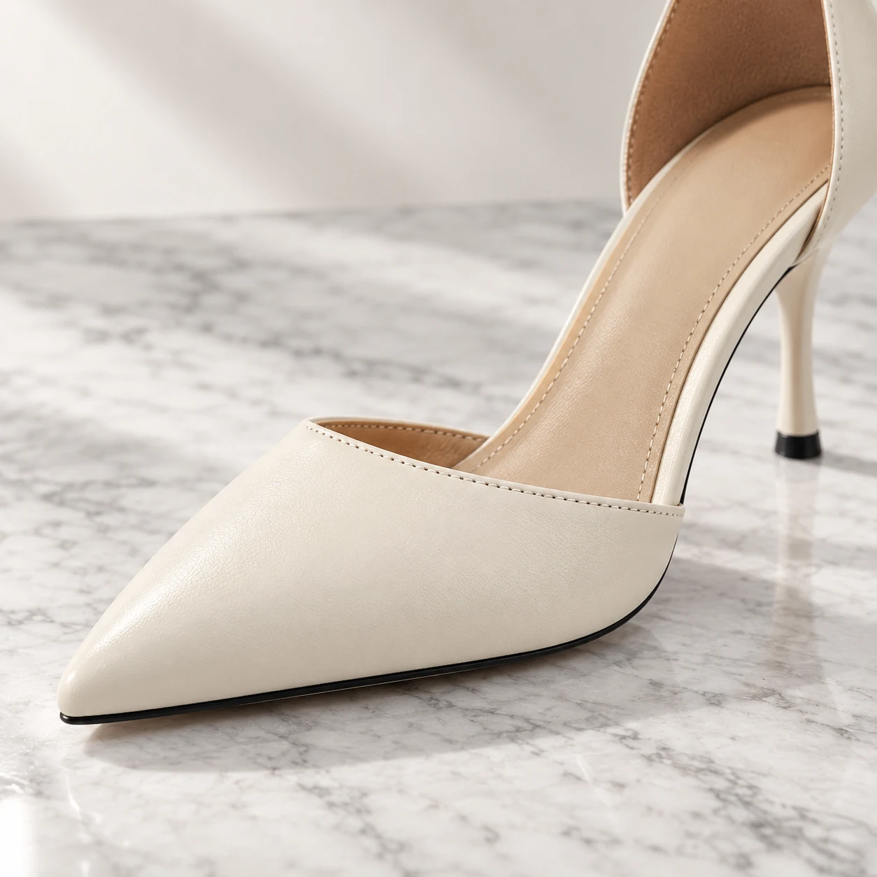 Close-up of the Ivory Grace pointed toe and d’Orsay side opening