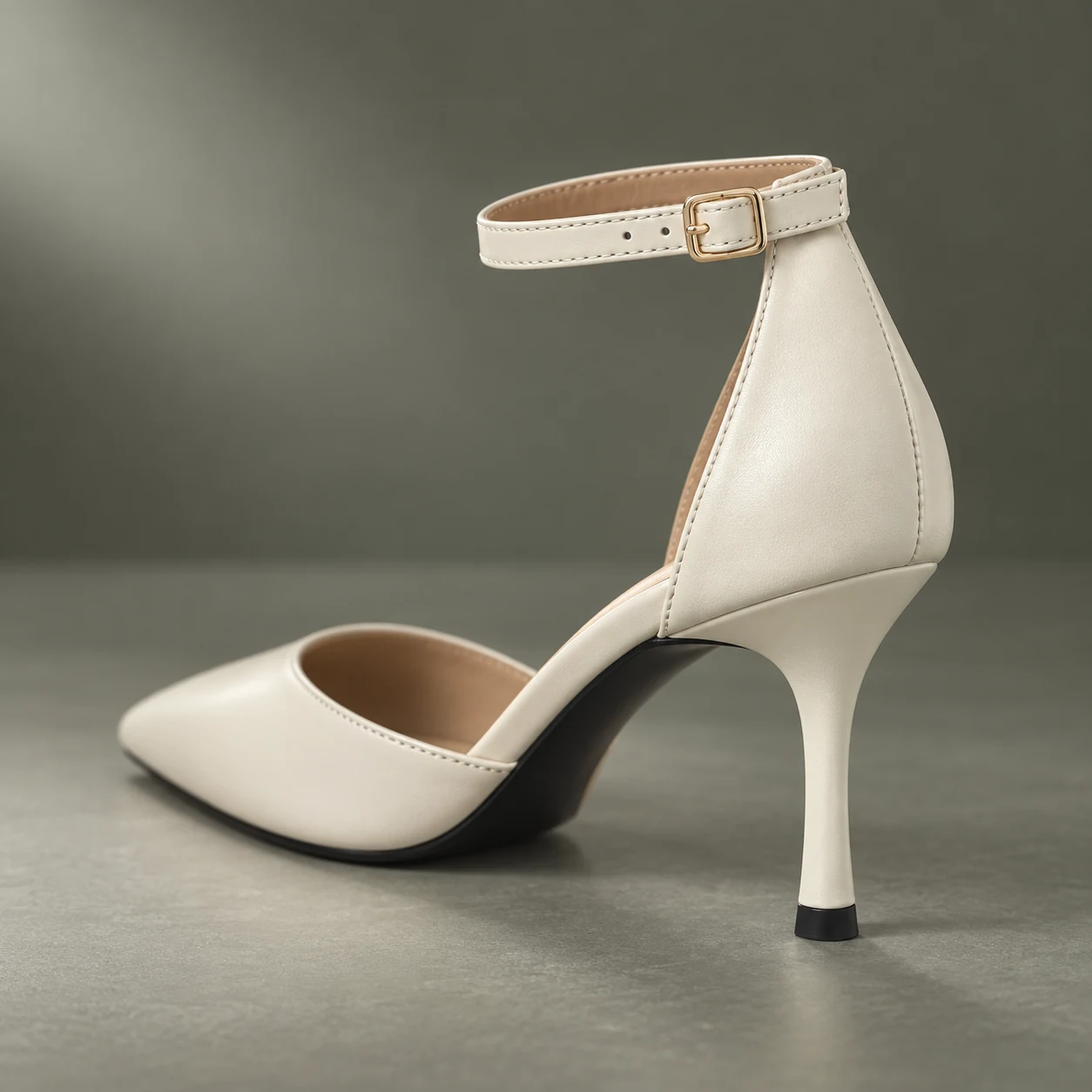 Close-up of the Ivory Grace ankle strap, pale-gold buckle and slim stiletto heel