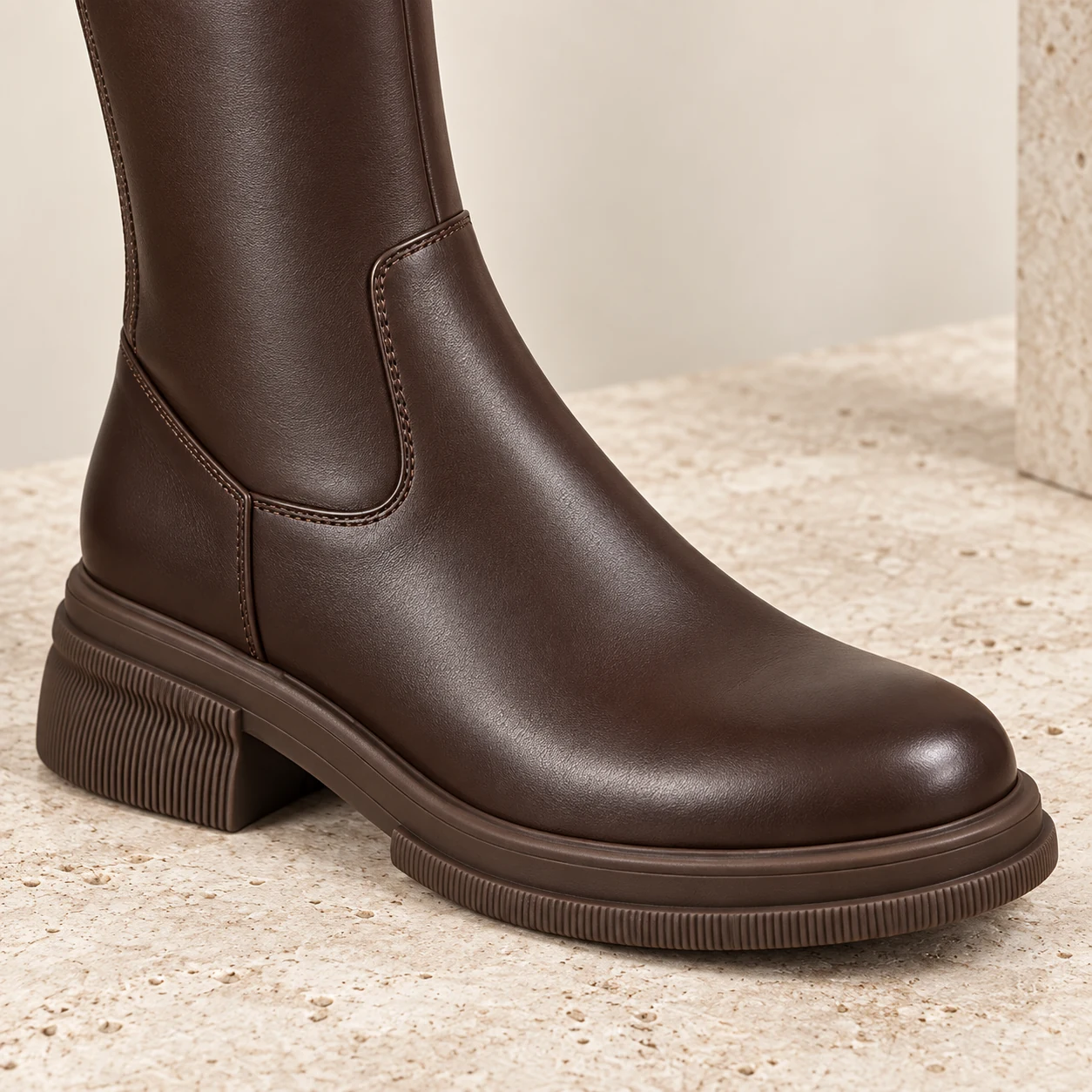 Close-up of the Brown Knee-High Boot leather toe, rubber outsole and block heel